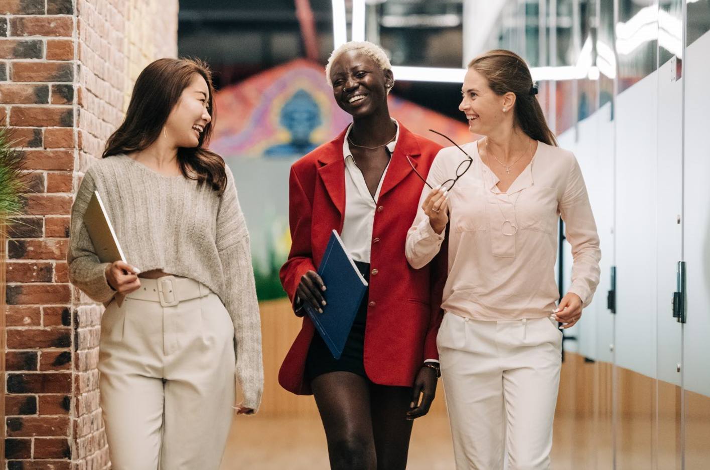 Photo of three colleagues walking together and laughing