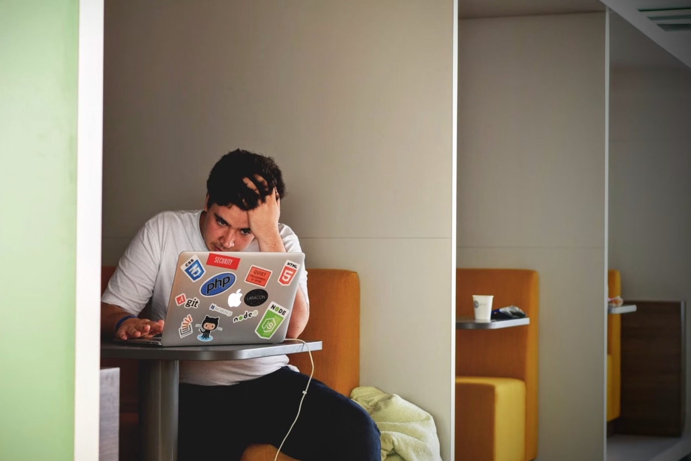 Photo of a stressed out employee working on a laptop