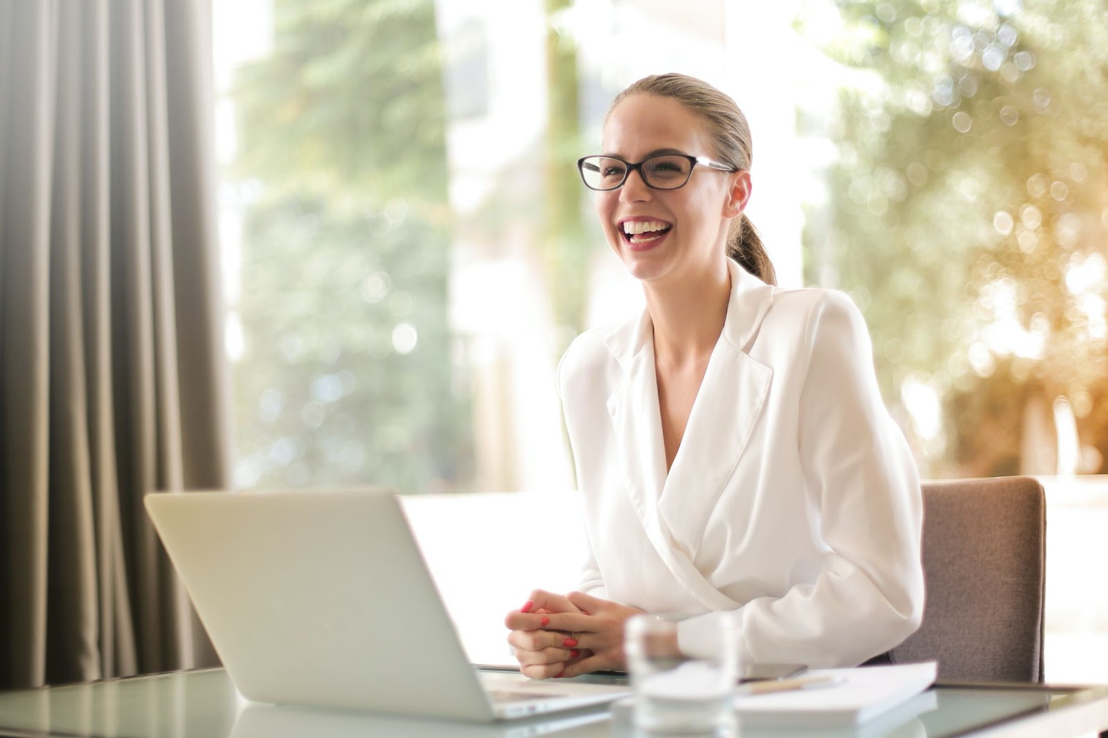 Photo of a happy-looking professional woman, laughing and smiling