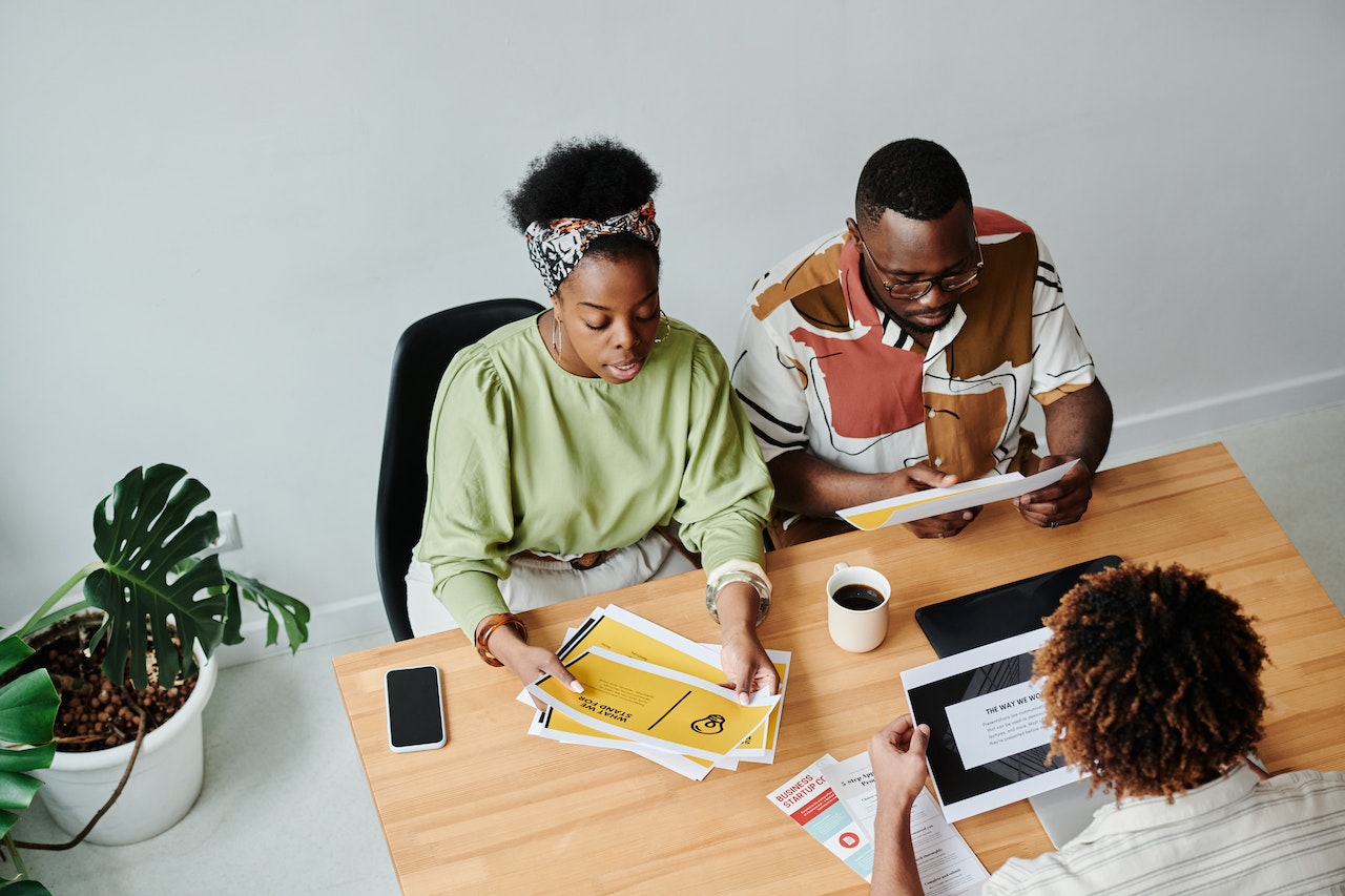 A photo of three collegues working at a table