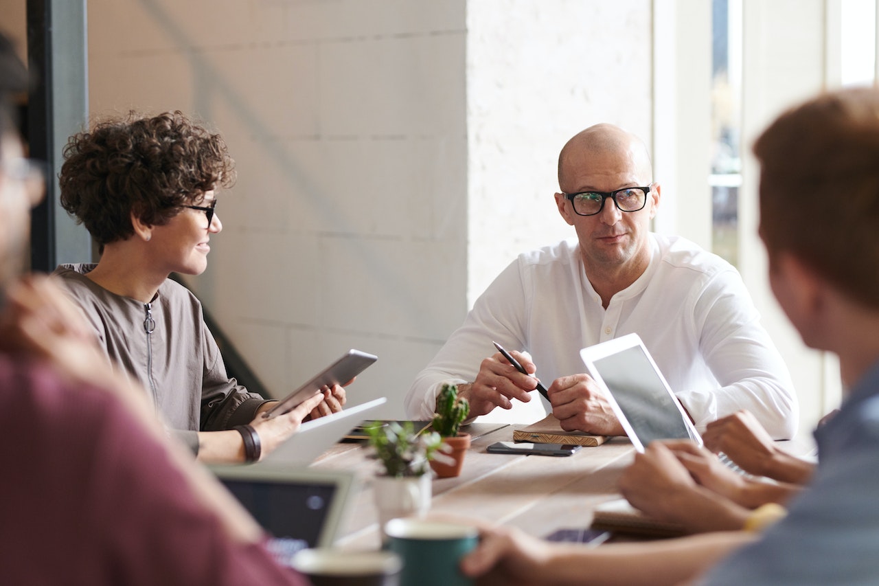 Photo of four employees in a meeting