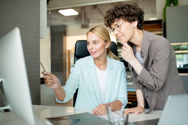 A photo of two employees creating an employee survey together.