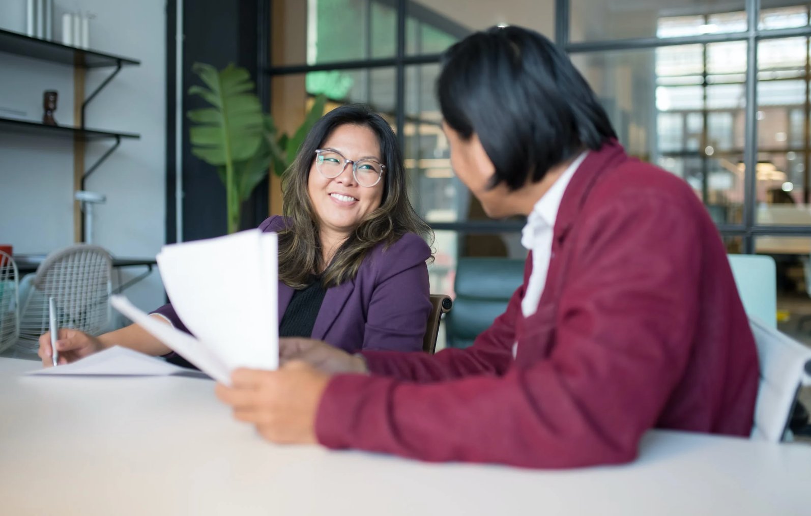 Photo of two professionals talking to each other