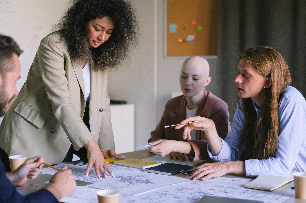 A photo of four employees working and planning together.