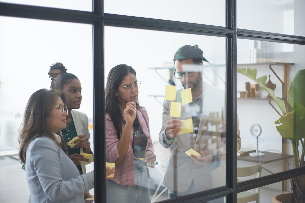 Photo of a group of four professionals engaged in a training activity.