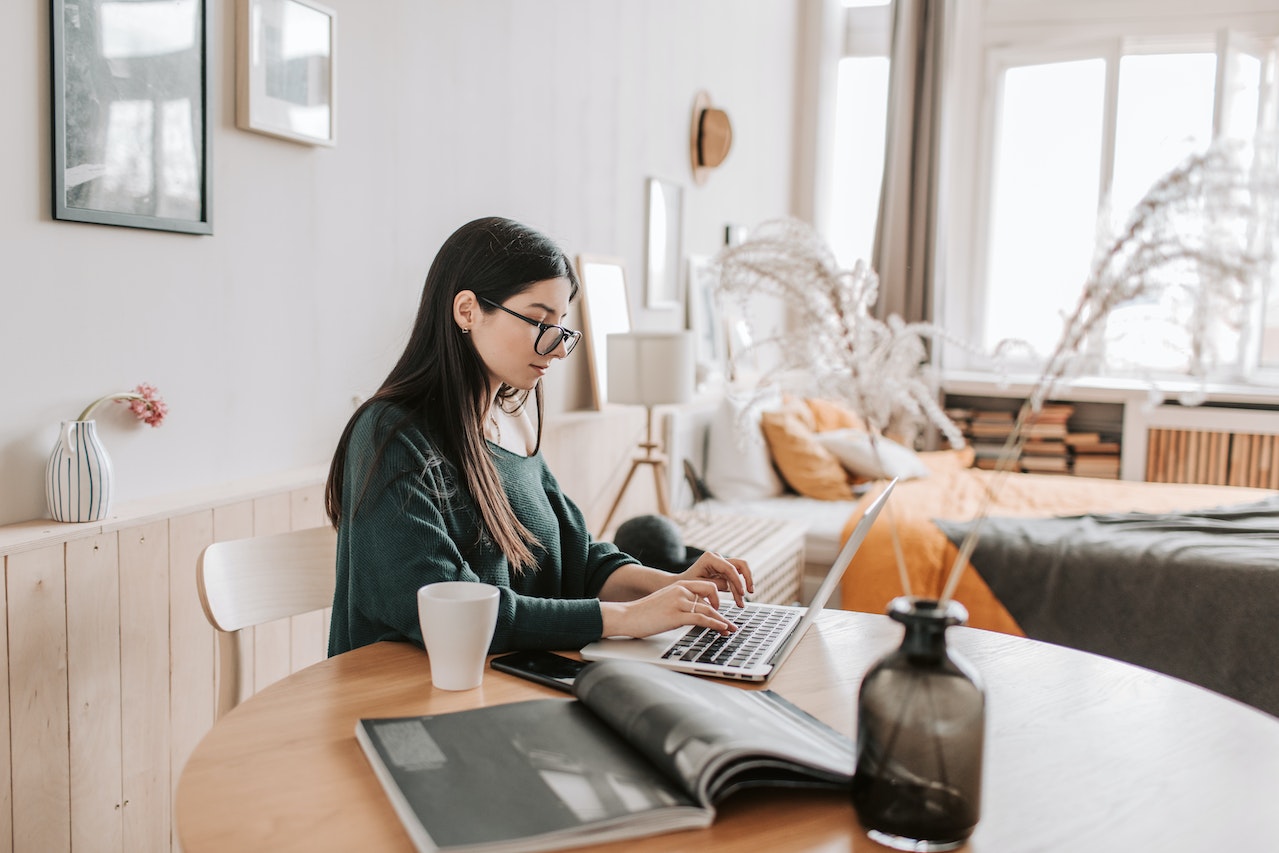 Photo of a professional doing asynchronous work in their living room.