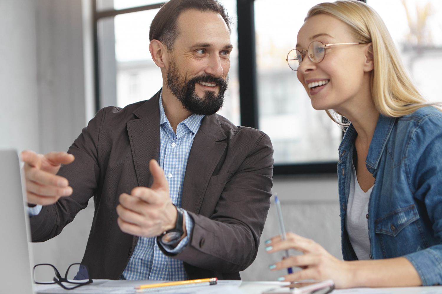 A photo of two professionals having a performance review.