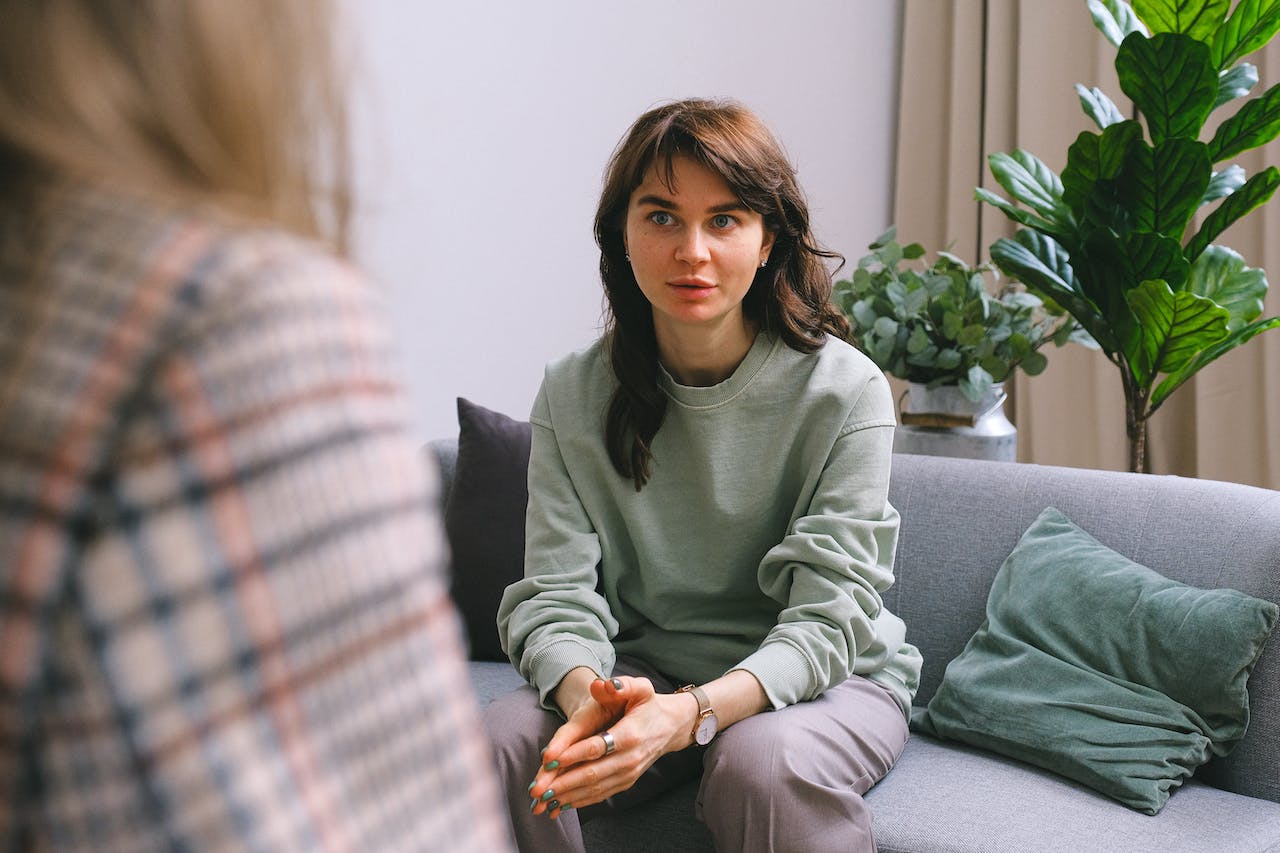 A photo of a professional talking to a colleague in a coaching session.