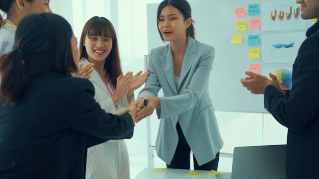 A photo of a manager celebrating employee success.