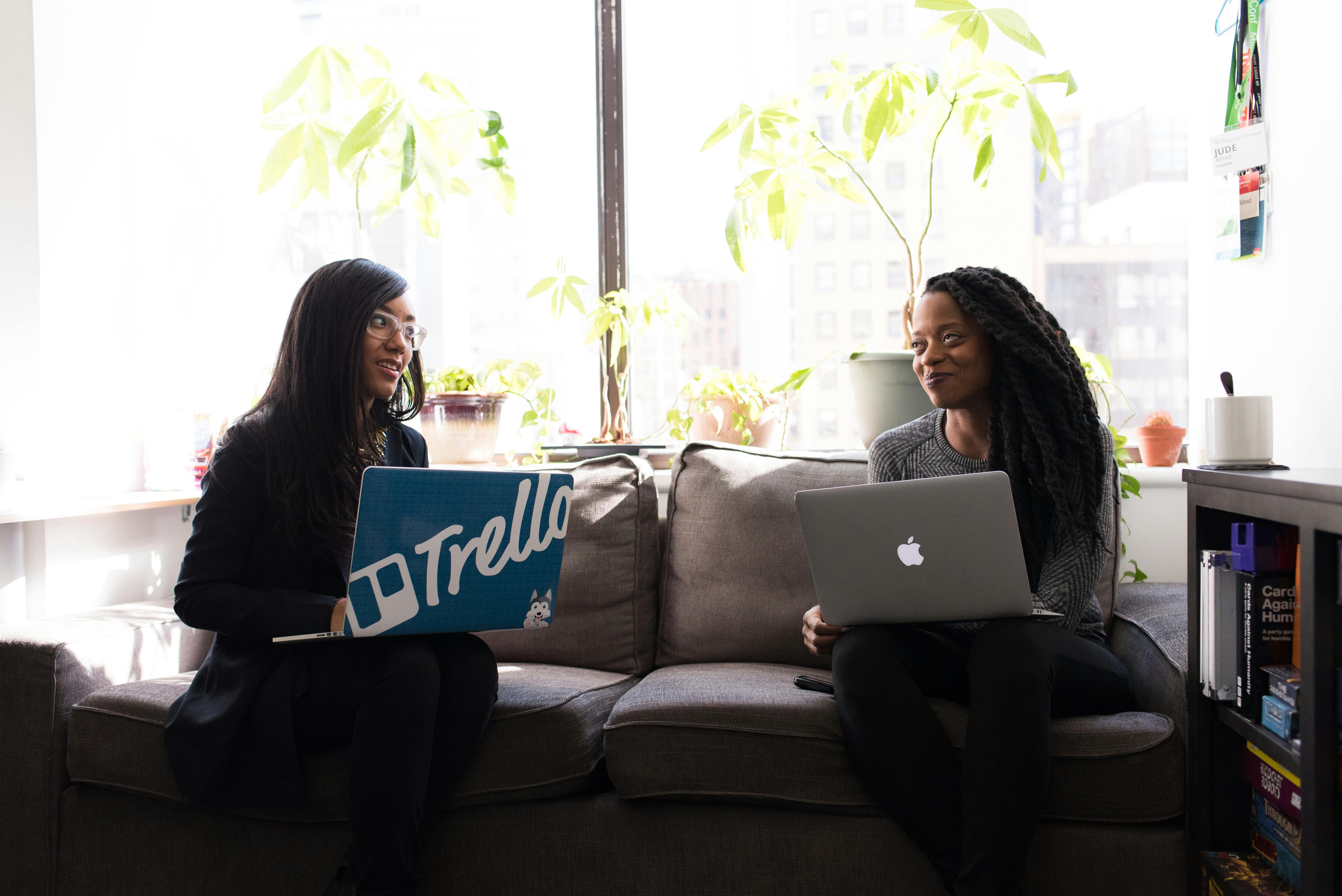 A photo of two professionals working together in a casual office environment.