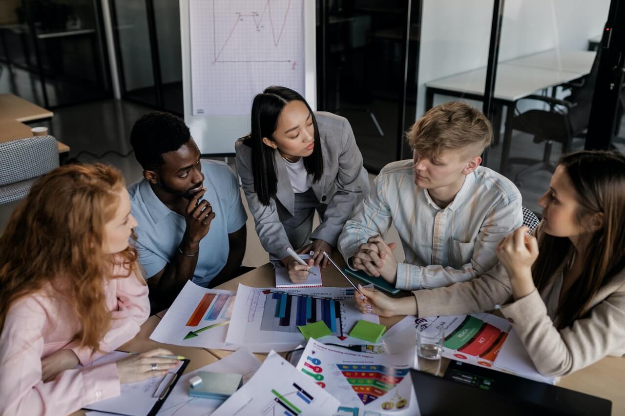 Image of a group of people discussing team goals